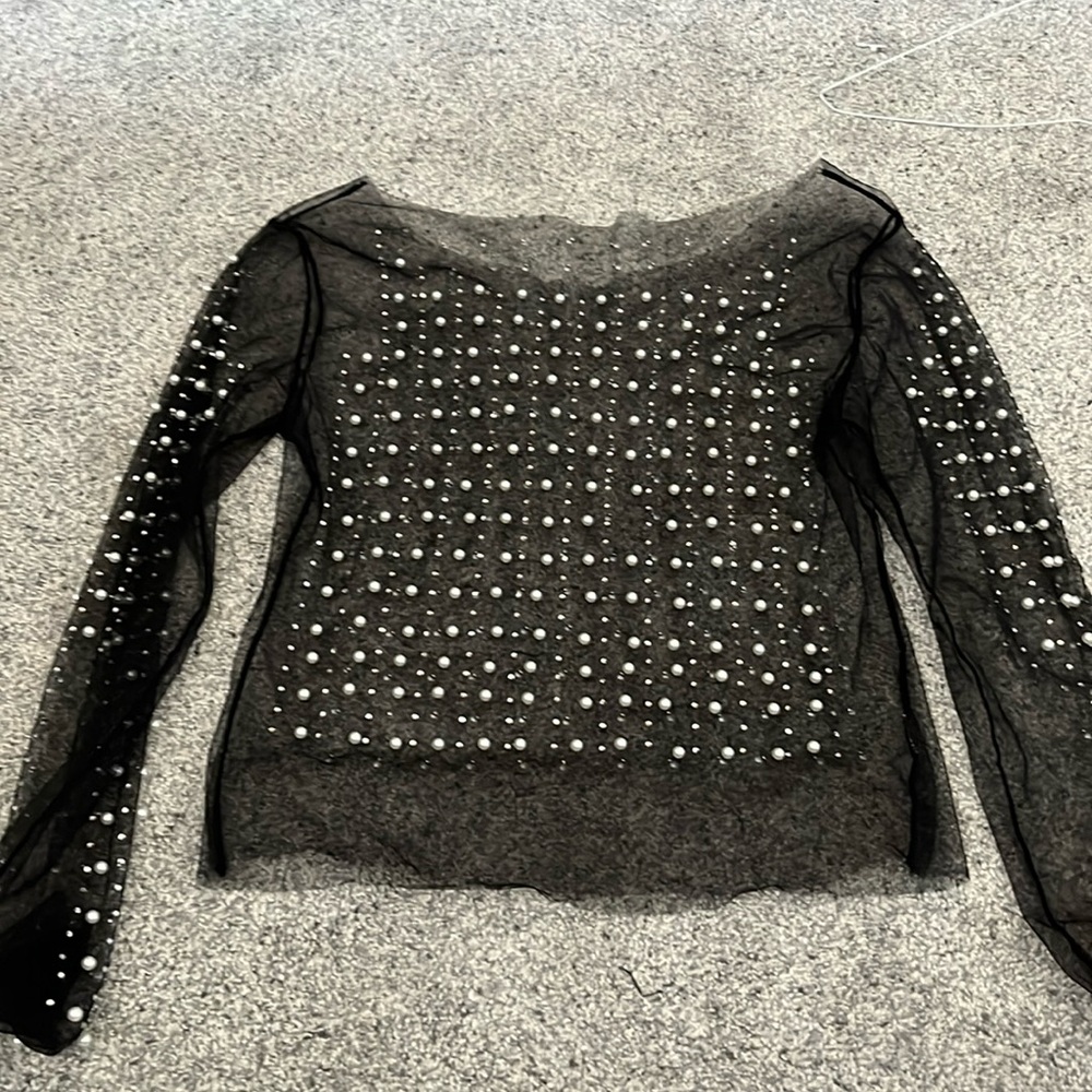 Black see-through shirt with pearls. Medium sized women’s wear.